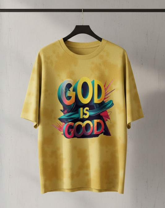 Yellow t-shirt with 'GOD IS GOOD' text on a hanger against a plain background